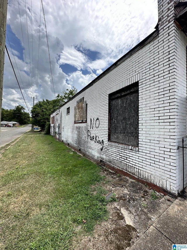 view of side of property with a yard