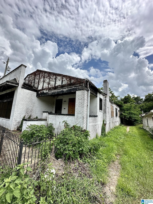 view of side of home with a yard