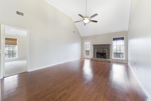 unfurnished living room featuring ceiling fan, high vaulted ceiling, dark wood-type flooring, and a fireplace