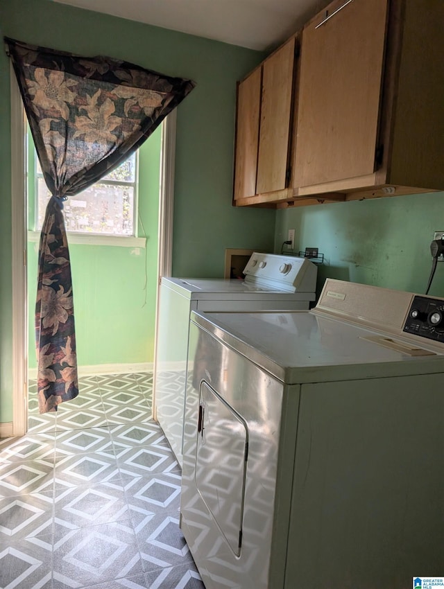 washroom featuring washer and dryer and cabinets