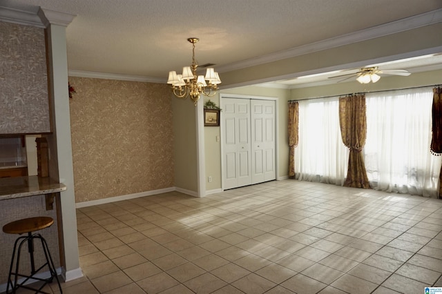 interior space with ceiling fan with notable chandelier, light tile patterned floors, crown molding, and a textured ceiling