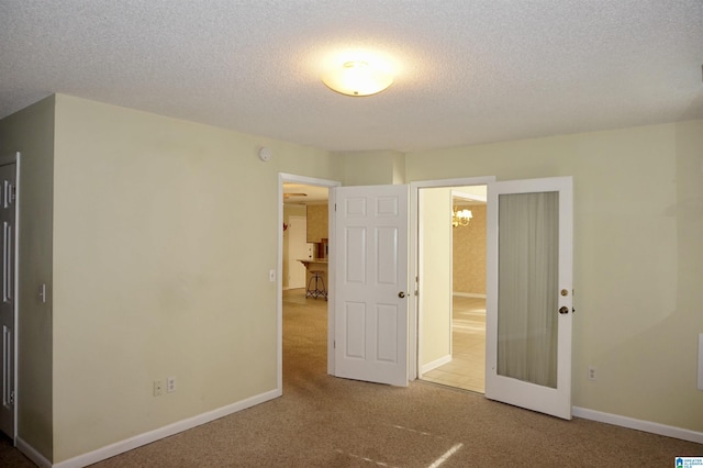 unfurnished bedroom with carpet floors and a textured ceiling