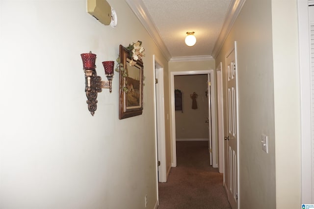 hallway featuring crown molding, dark colored carpet, and a textured ceiling