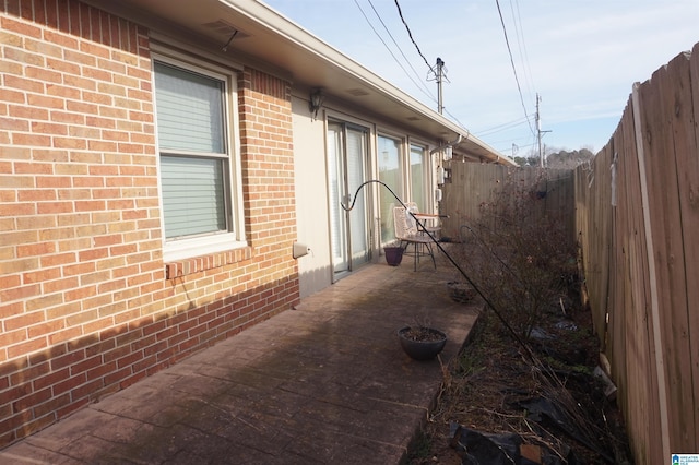 view of side of home featuring a patio