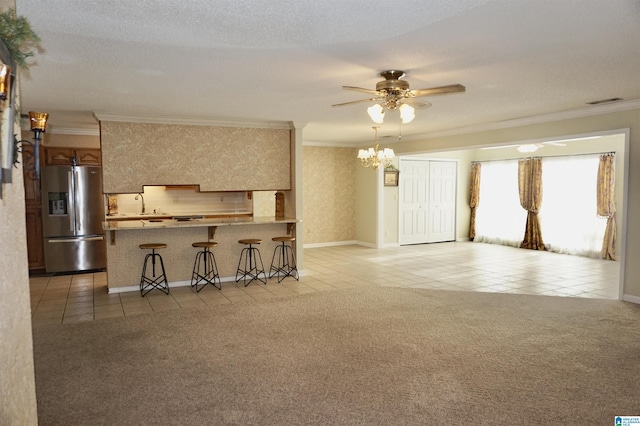 unfurnished living room with a textured ceiling, crown molding, light colored carpet, and ceiling fan