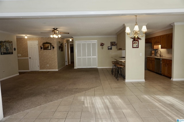 interior space with light carpet, crown molding, sink, and ceiling fan with notable chandelier