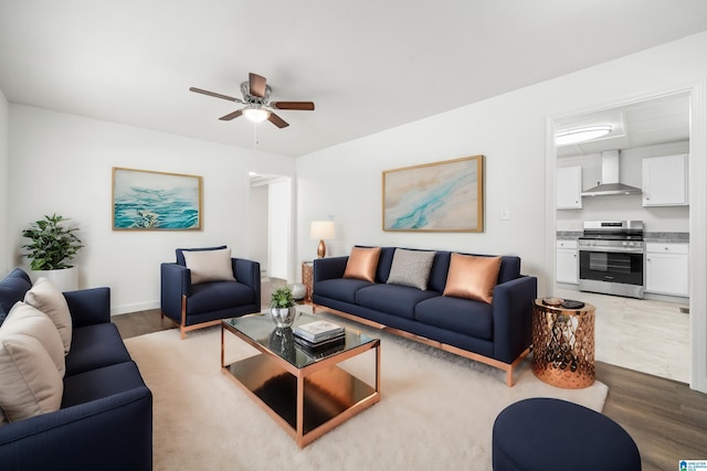 living room featuring hardwood / wood-style floors and ceiling fan