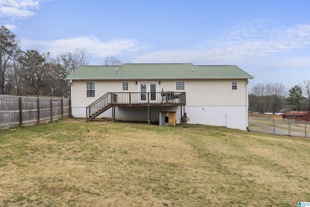 back of house with a lawn, a fenced backyard, metal roof, stairs, and a deck