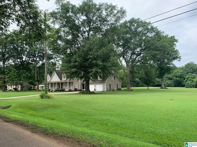 view of front of home with a front lawn and an attached garage