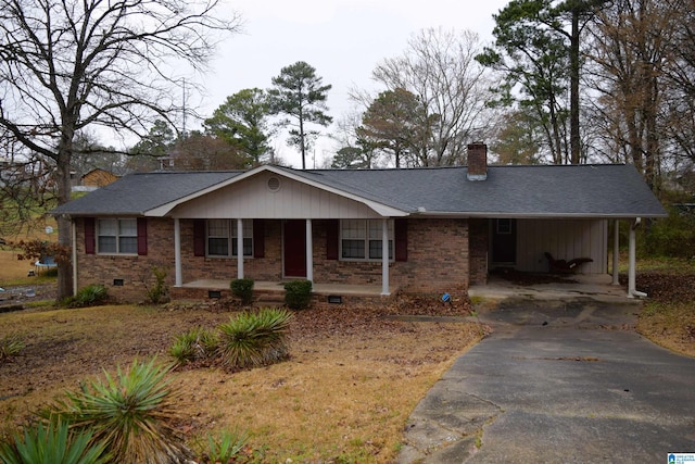 ranch-style home featuring covered porch and a carport