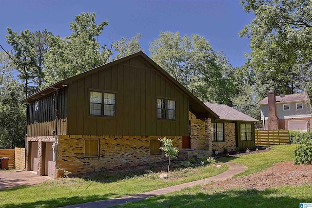 view of front facade with driveway, an attached garage, board and batten siding, and brick siding