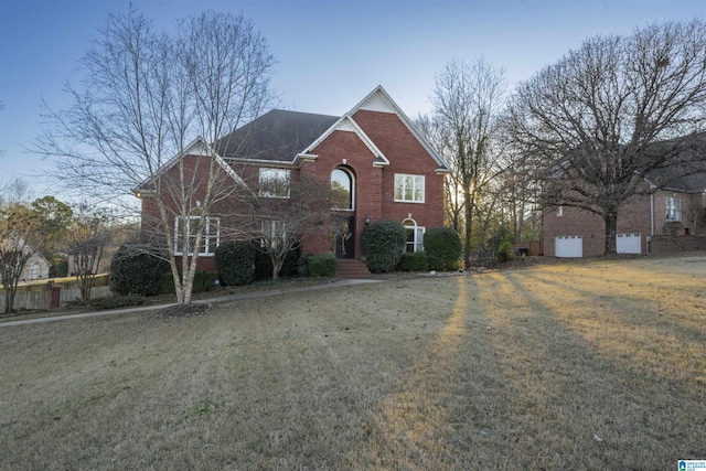 view of front of house featuring brick siding and a front yard