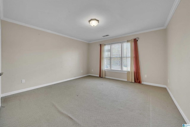 carpeted spare room featuring ornamental molding, visible vents, and baseboards