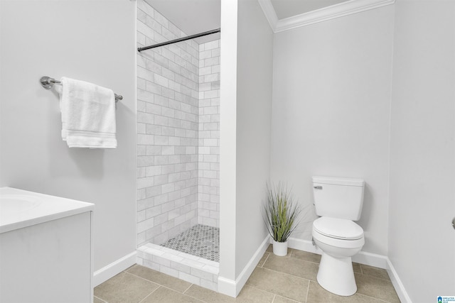 full bath featuring toilet, baseboards, ornamental molding, a shower stall, and tile patterned floors