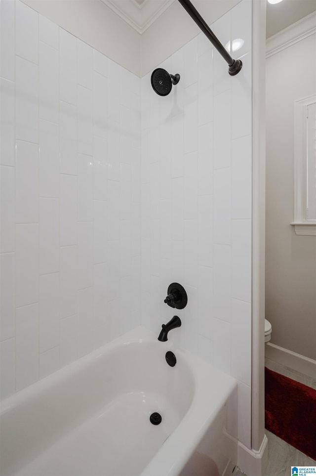 full bathroom with baseboards, tub / shower combination, toilet, and crown molding