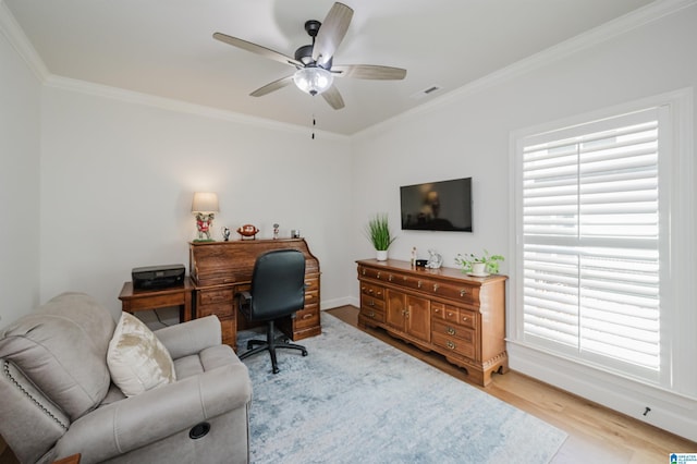 home office with ornamental molding, a ceiling fan, visible vents, and wood finished floors