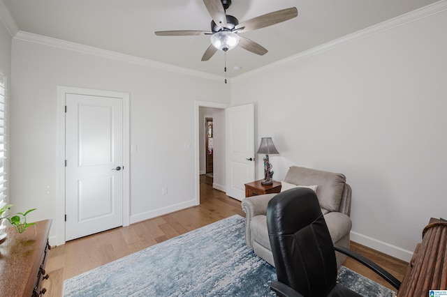 living area with ornamental molding, baseboards, and wood finished floors