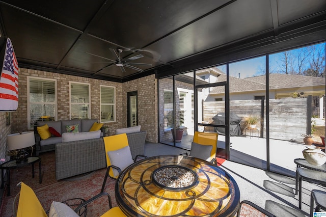 sunroom with a wealth of natural light and ceiling fan