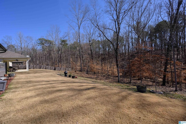 view of yard featuring a forest view