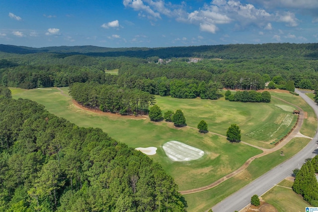 birds eye view of property featuring golf course view and a view of trees