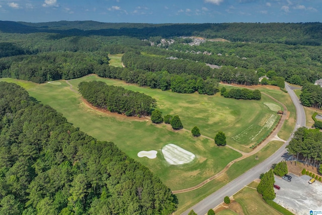 birds eye view of property featuring a forest view and view of golf course