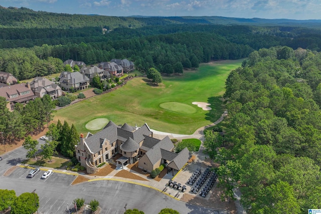 aerial view featuring view of golf course and a view of trees