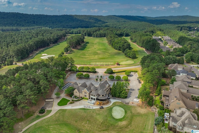 aerial view featuring a wooded view and golf course view