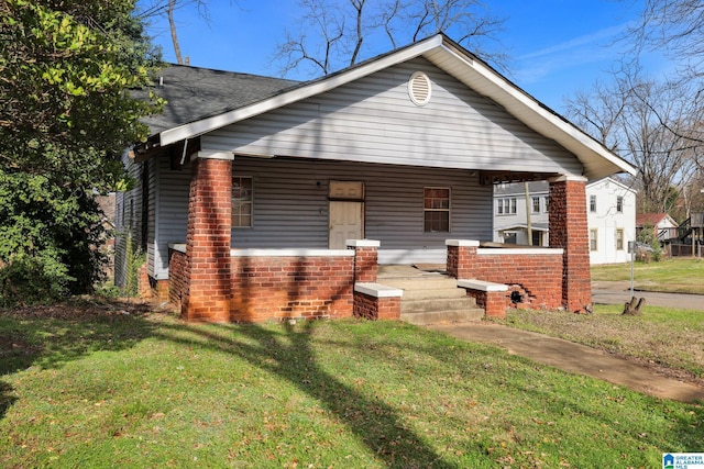 bungalow-style home with a front lawn and a porch