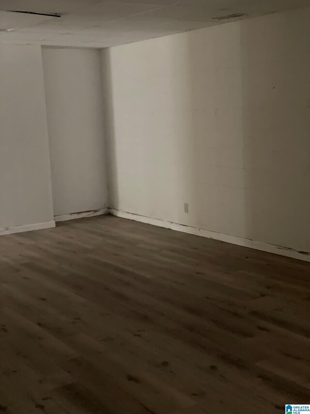 empty room featuring wood finished floors and baseboards