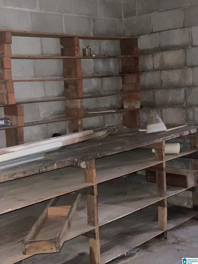 interior space with concrete block wall and concrete flooring