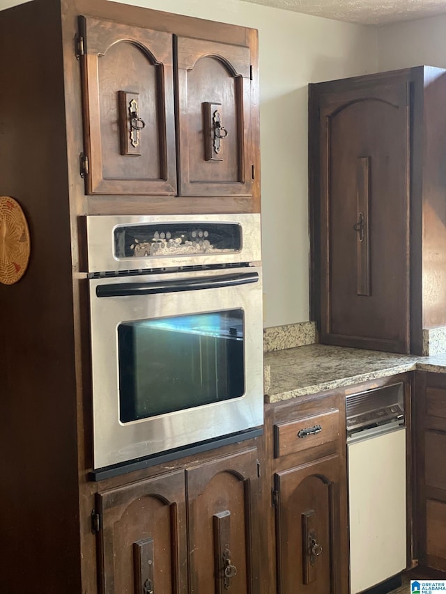 kitchen with light countertops and stainless steel oven