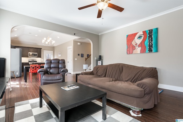 living area with arched walkways, stairway, ornamental molding, wood finished floors, and baseboards