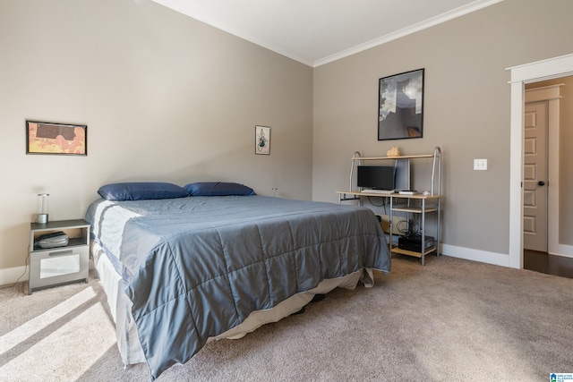 carpeted bedroom with ornamental molding and baseboards