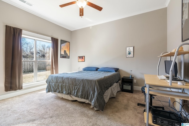 bedroom with carpet floors, baseboards, visible vents, and crown molding