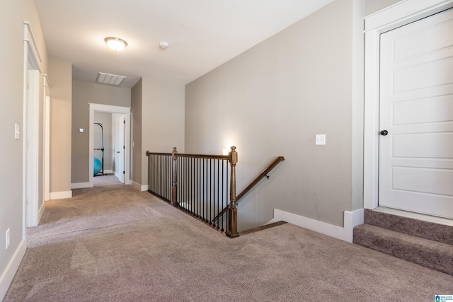 interior space featuring carpet, visible vents, and baseboards