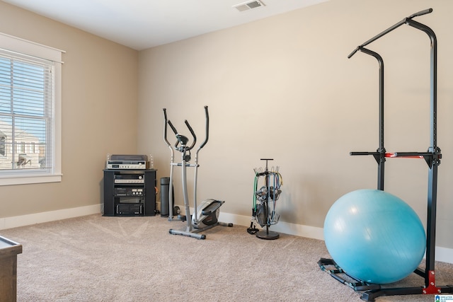 workout area featuring carpet floors, baseboards, and visible vents