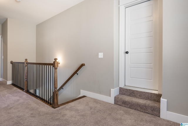 staircase with carpet floors and baseboards