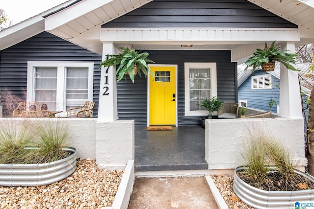 view of exterior entry with covered porch