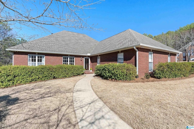 single story home with a shingled roof and brick siding