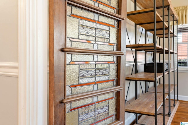 stairs with baseboards and wood finished floors