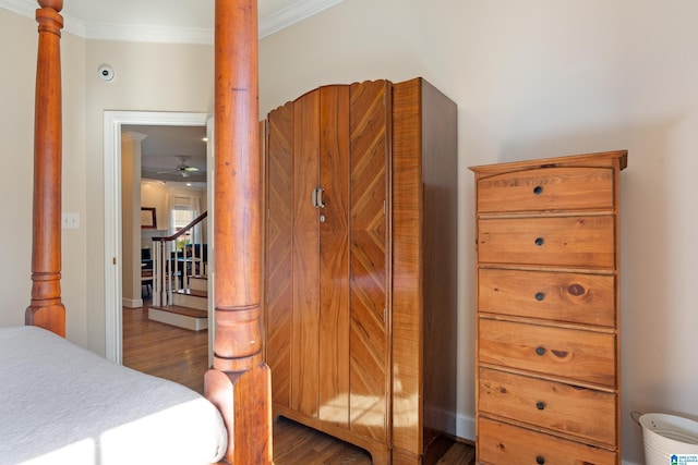 bedroom featuring ornamental molding and dark wood-type flooring