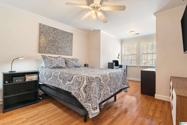 bedroom with ornamental molding, a ceiling fan, baseboards, and wood finished floors