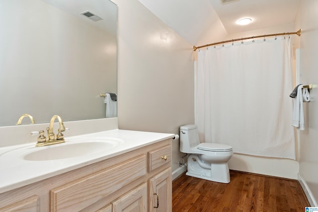 bathroom featuring toilet, wood finished floors, visible vents, vanity, and shower / bath combination with curtain