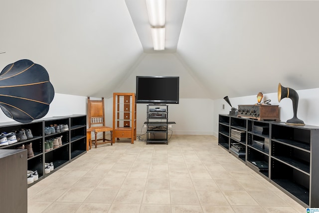 bonus room featuring vaulted ceiling, tile patterned flooring, and baseboards