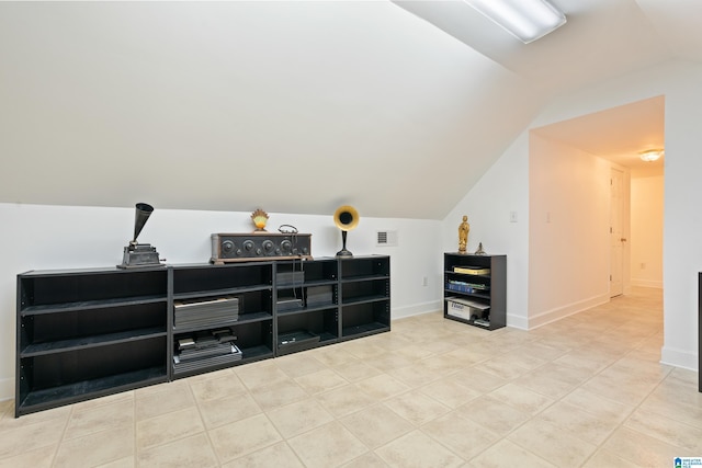 bonus room with lofted ceiling, tile patterned flooring, visible vents, and baseboards