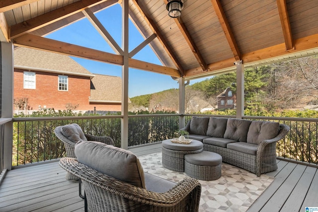 wooden terrace with an outdoor hangout area