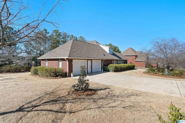 view of front of property with a garage, concrete driveway, brick siding, and a shingled roof