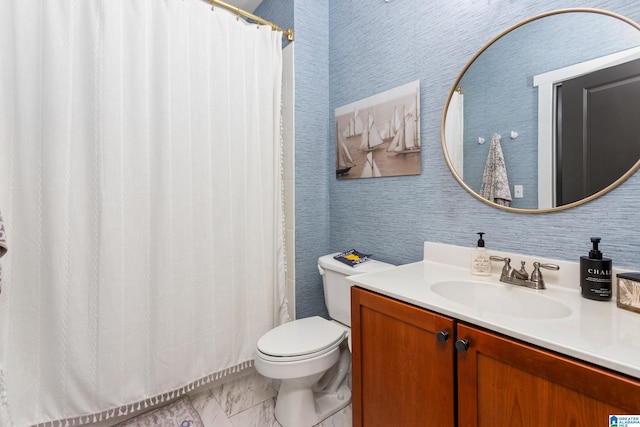 bathroom featuring marble finish floor, toilet, vanity, a shower with curtain, and wallpapered walls