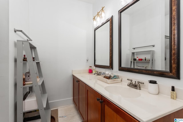 bathroom with a sink, baseboards, and double vanity