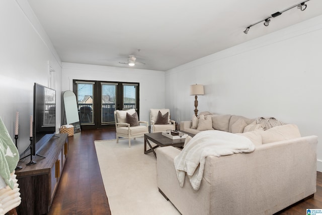 living area featuring a ceiling fan, rail lighting, and dark wood finished floors